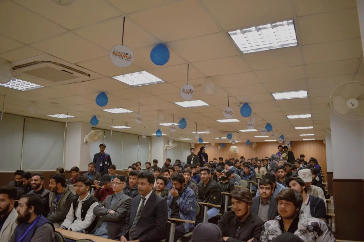 A packed lecture hall at a university science event